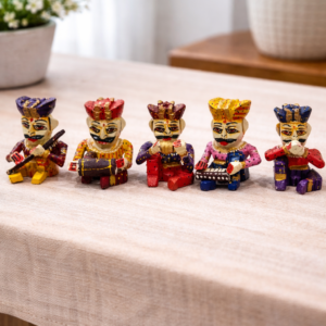Set of five hand‑painted Babla musicians in traditional Rajasthani attire with folk instruments on wooden surface”