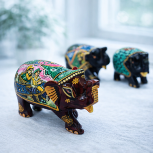 Hand‑painted Kala Haathi figurines with multicolour Rajasthani folk art on wooden surface