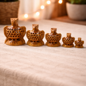 “Set of five Kadamb wood eagle figurines with hidden baby eagles inside lattice carving; Kadamb wood specialty for precision detailing