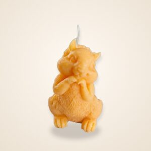 Golden Squirrel Whisper Candle, on a cream background