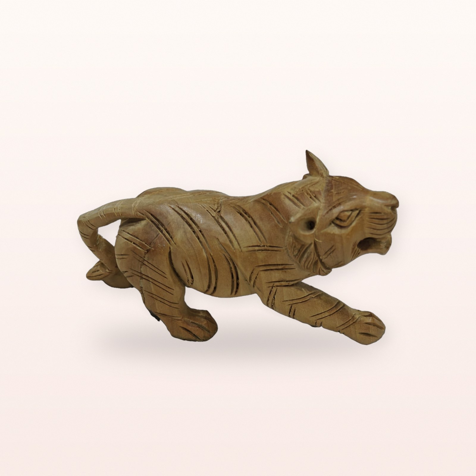 Wooden Tiger Figurine, on a soft blush background