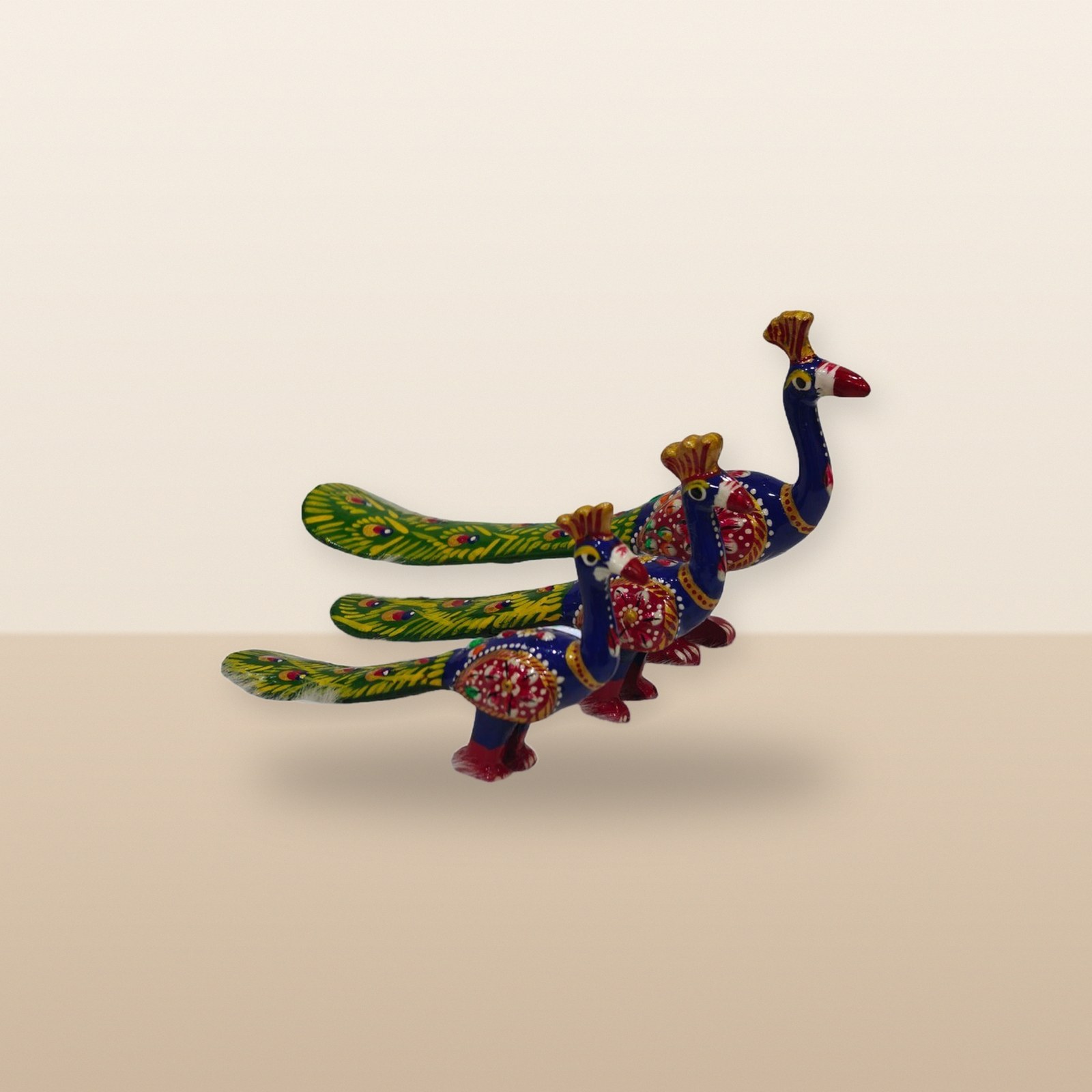 Blue Green Peacock figurines, on a tabletop