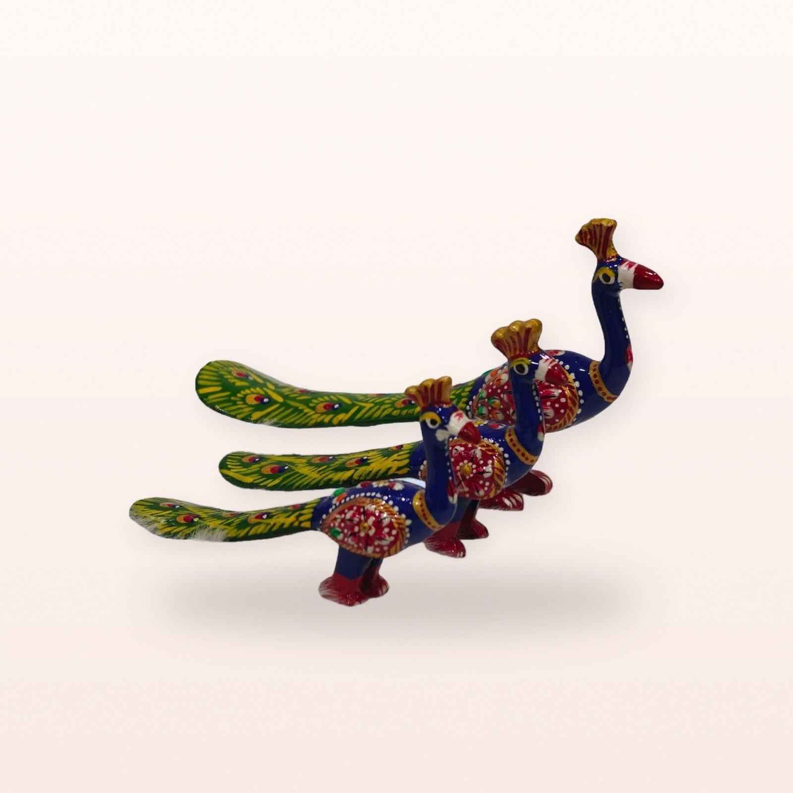 Blue Green Peacock figurines, on a soft blush background