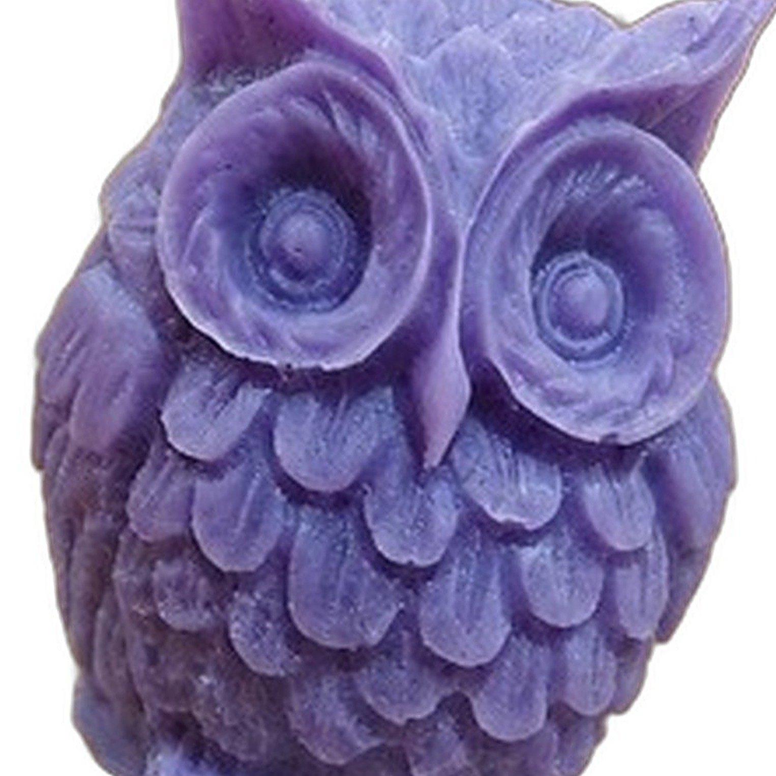 Close up of the carved feathers and eyes on a purple Owl Candle