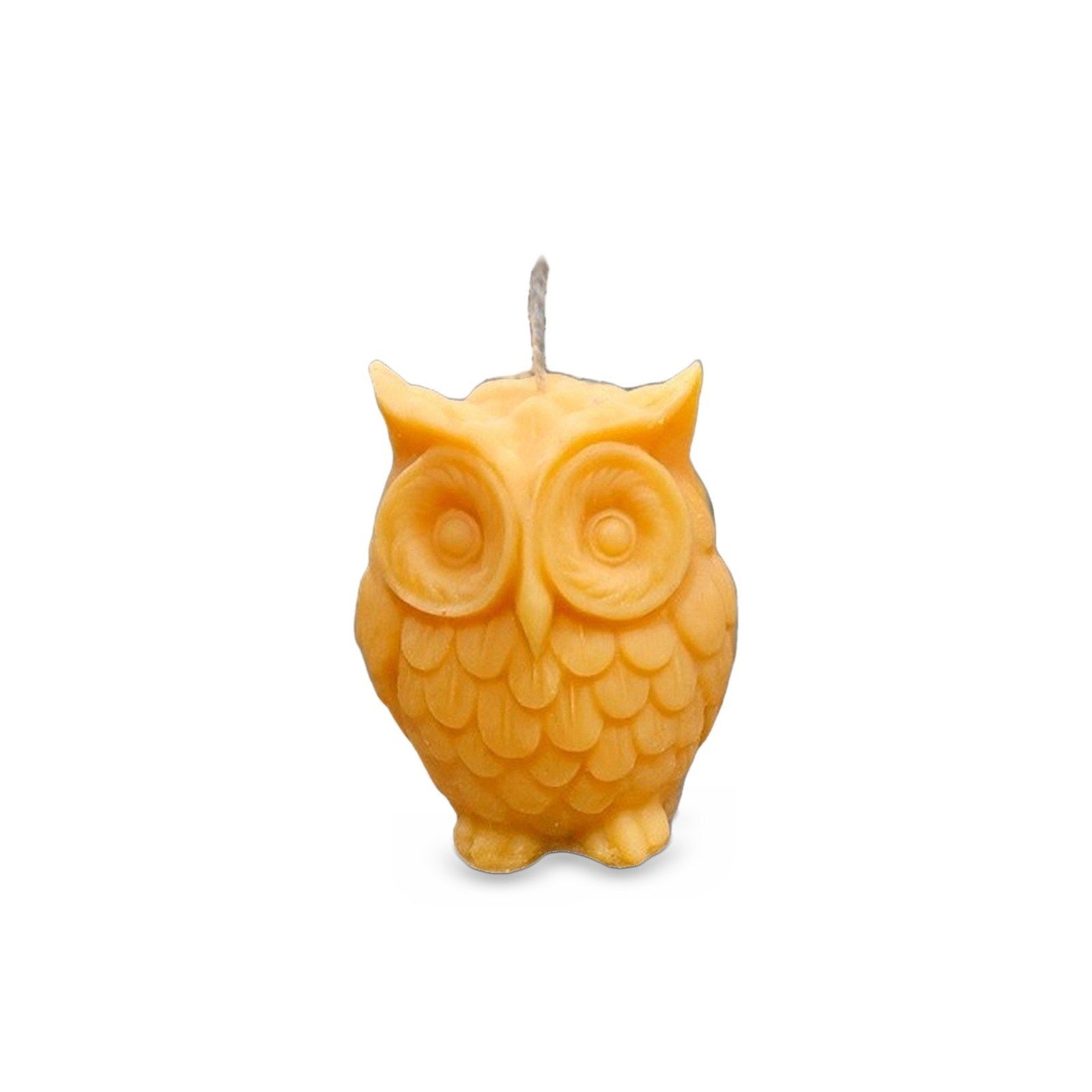 Yellow Owl Candle with carved feathers and round eyes, front view on white