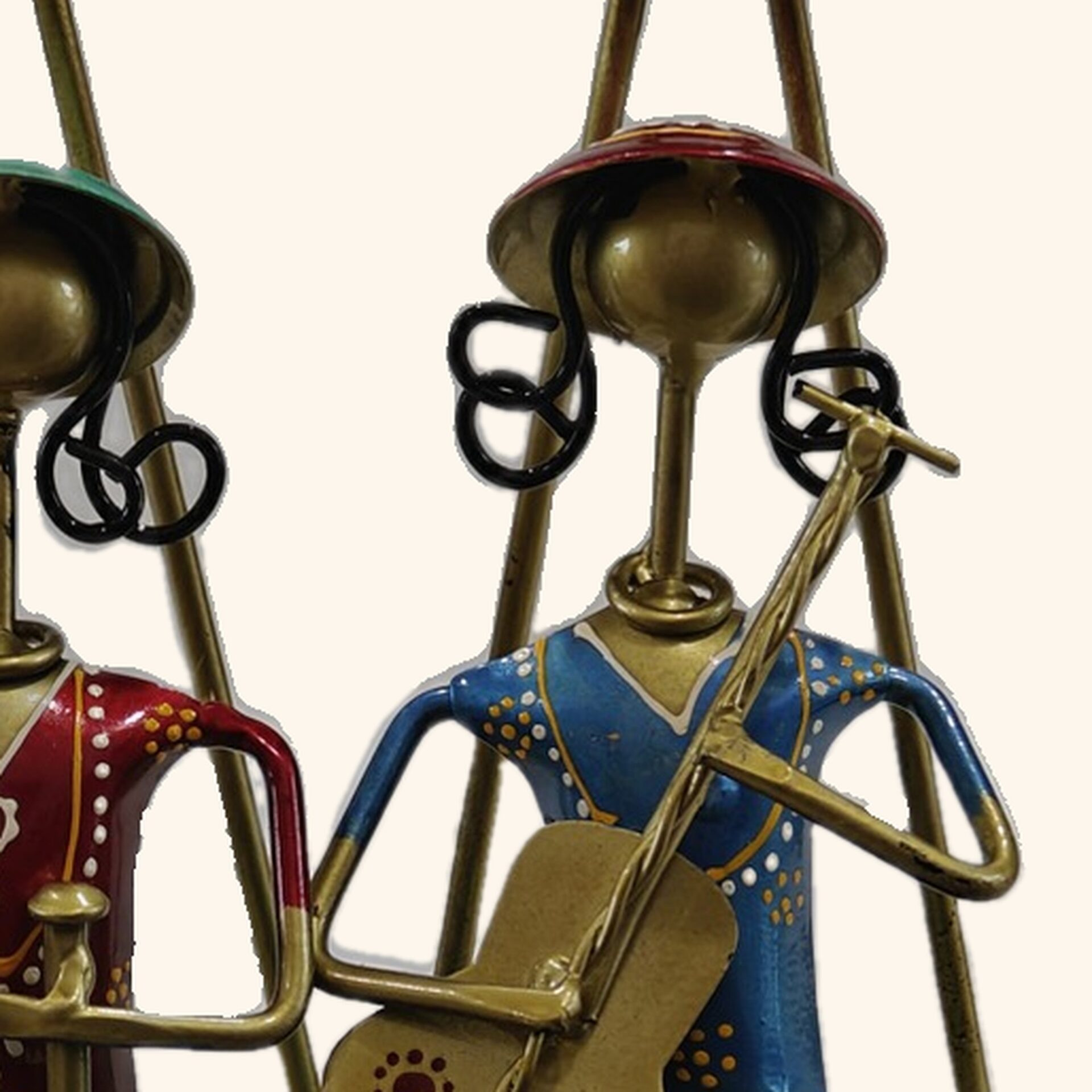 Close up of the painted face and instrument on a metal musician figure