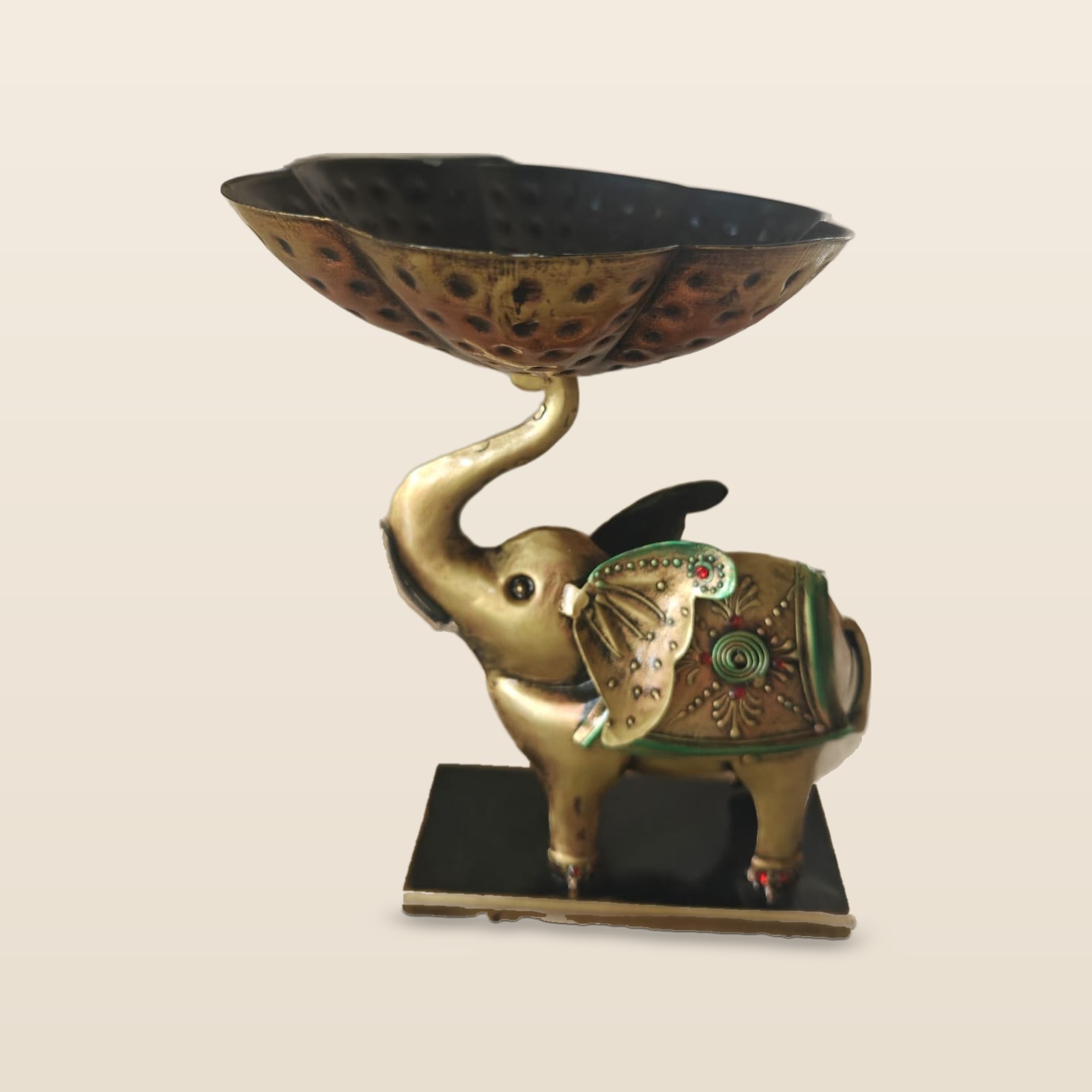 Gajraj elephant urli, dry fruit bowl on the trunk, on a cream background